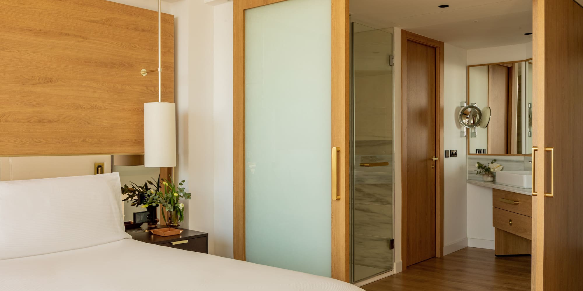 a bedroom with a bed and a glass door