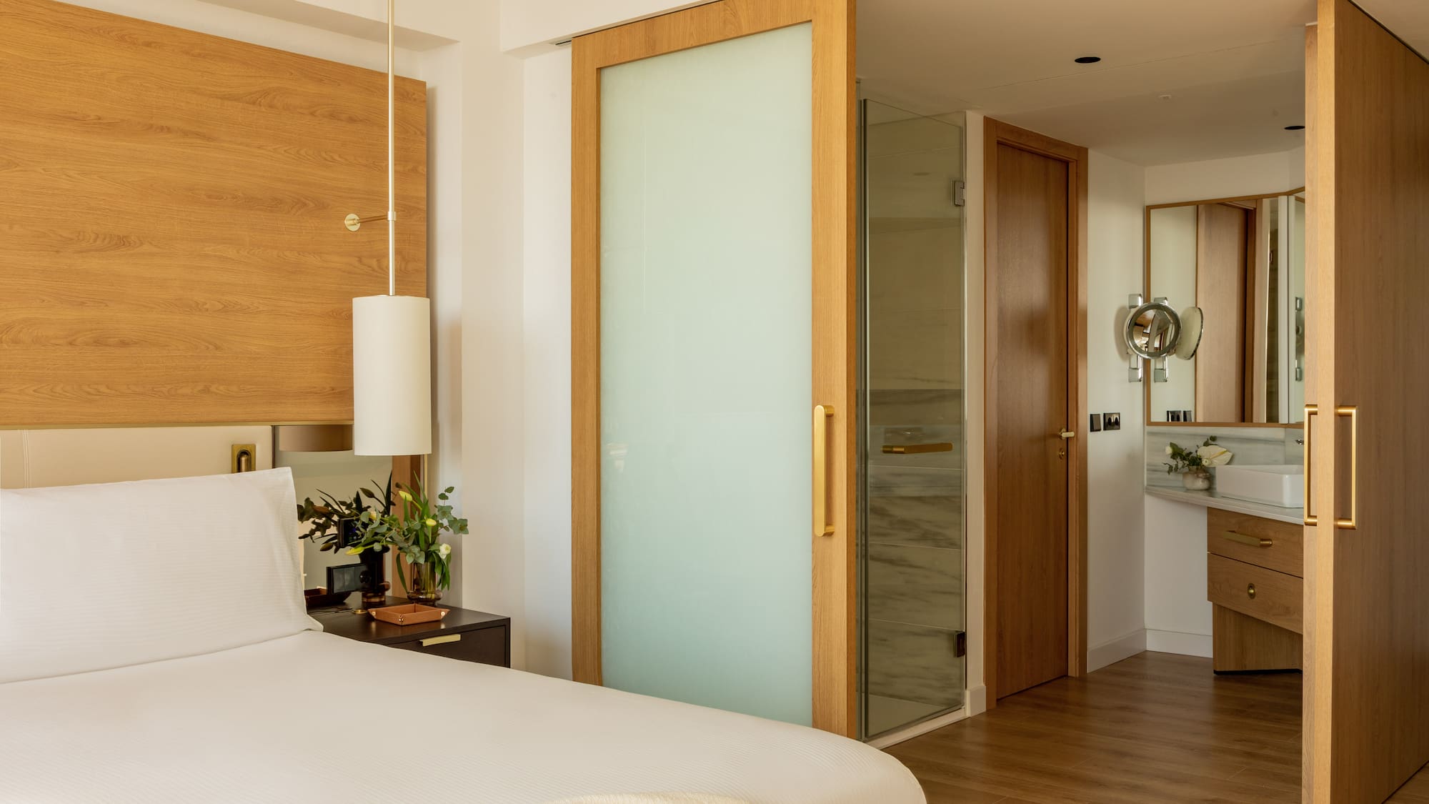 a bedroom with a bed and a glass door