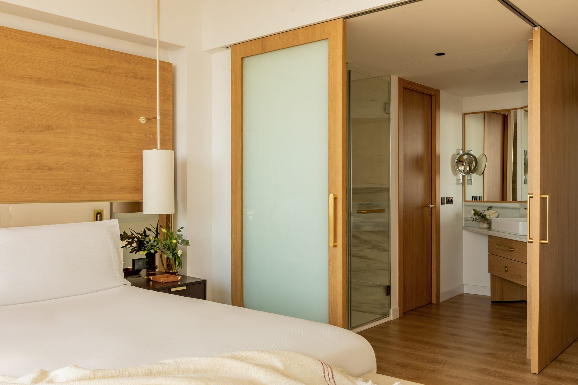 a bedroom with a bed and a glass door