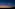 Glowing sky lantern above temple spires and mountains at sunset.