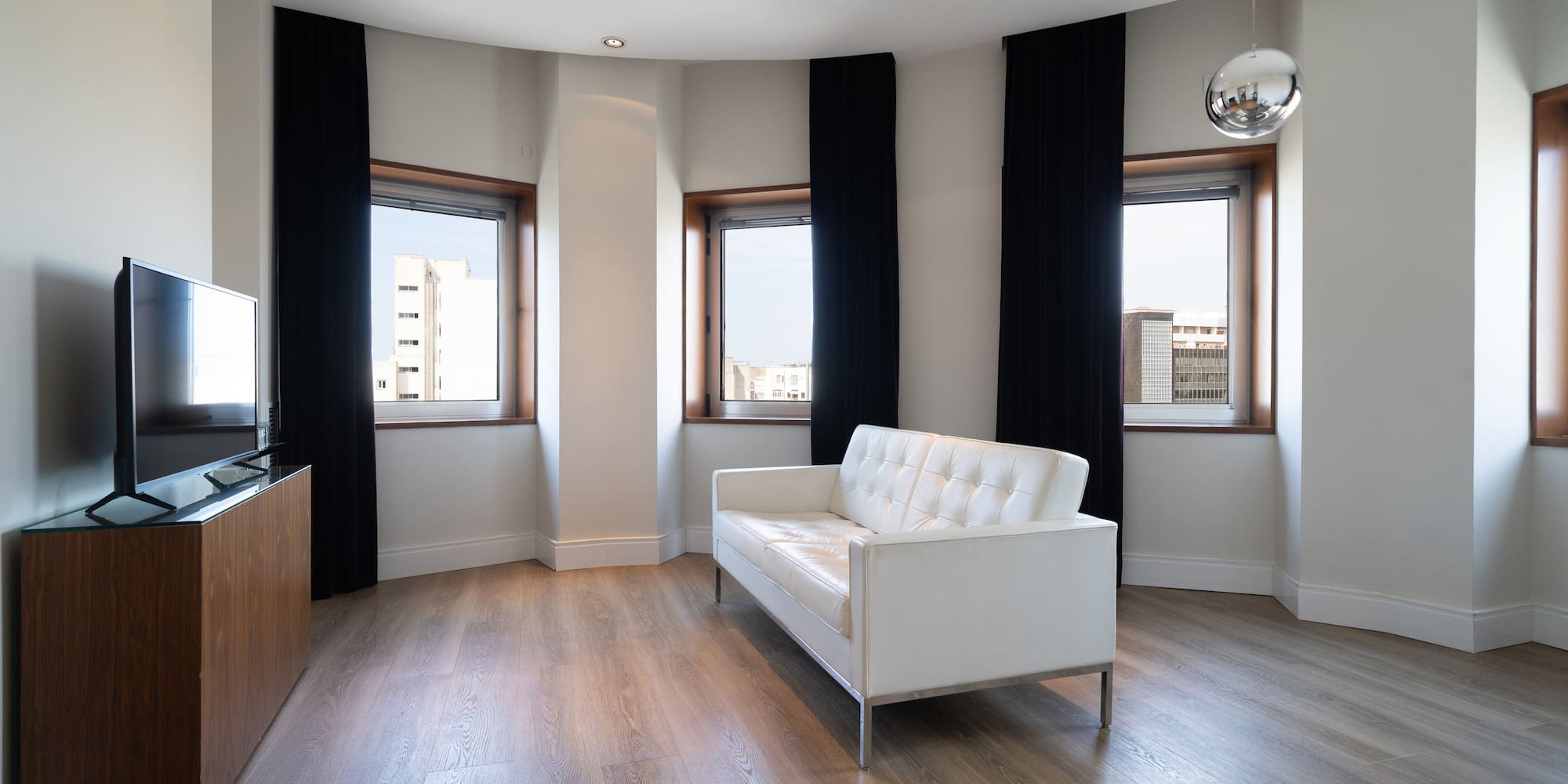 a room with a couch and windows