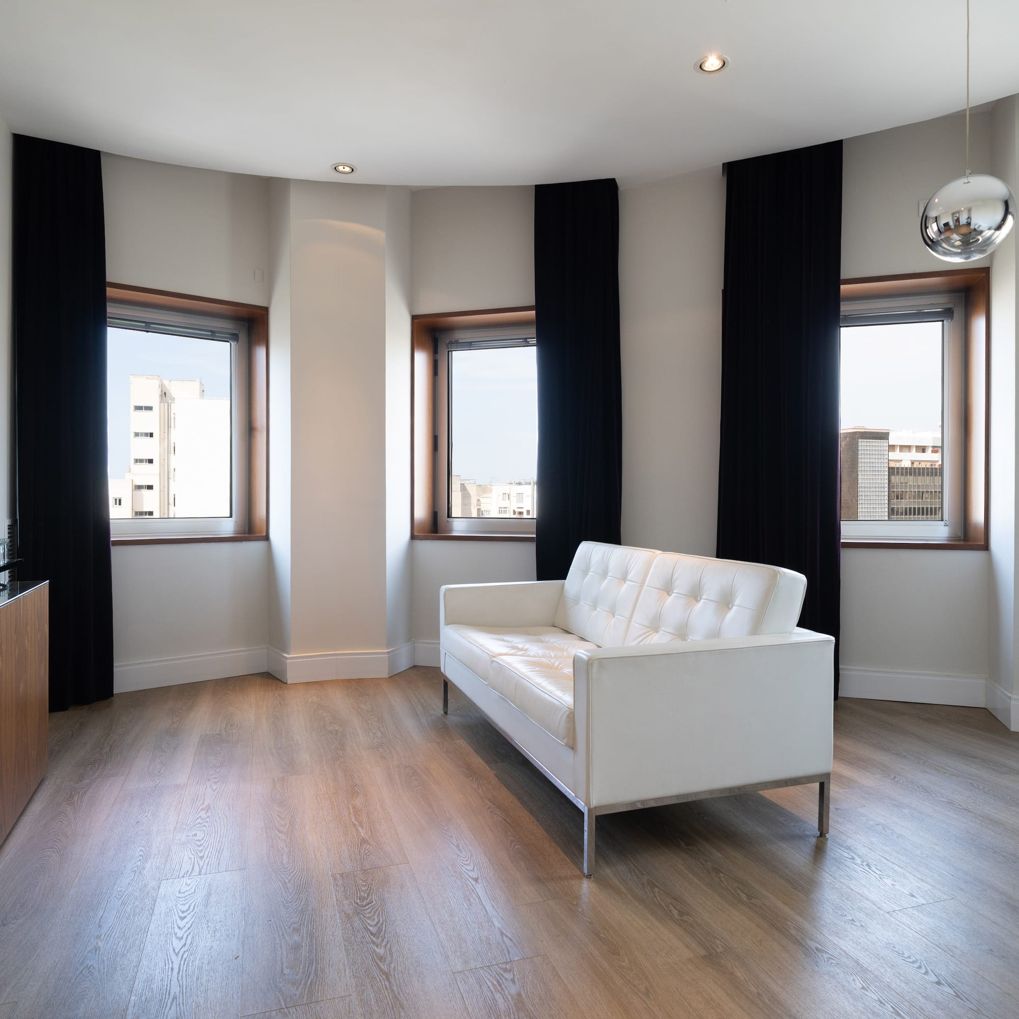 a room with a couch and windows