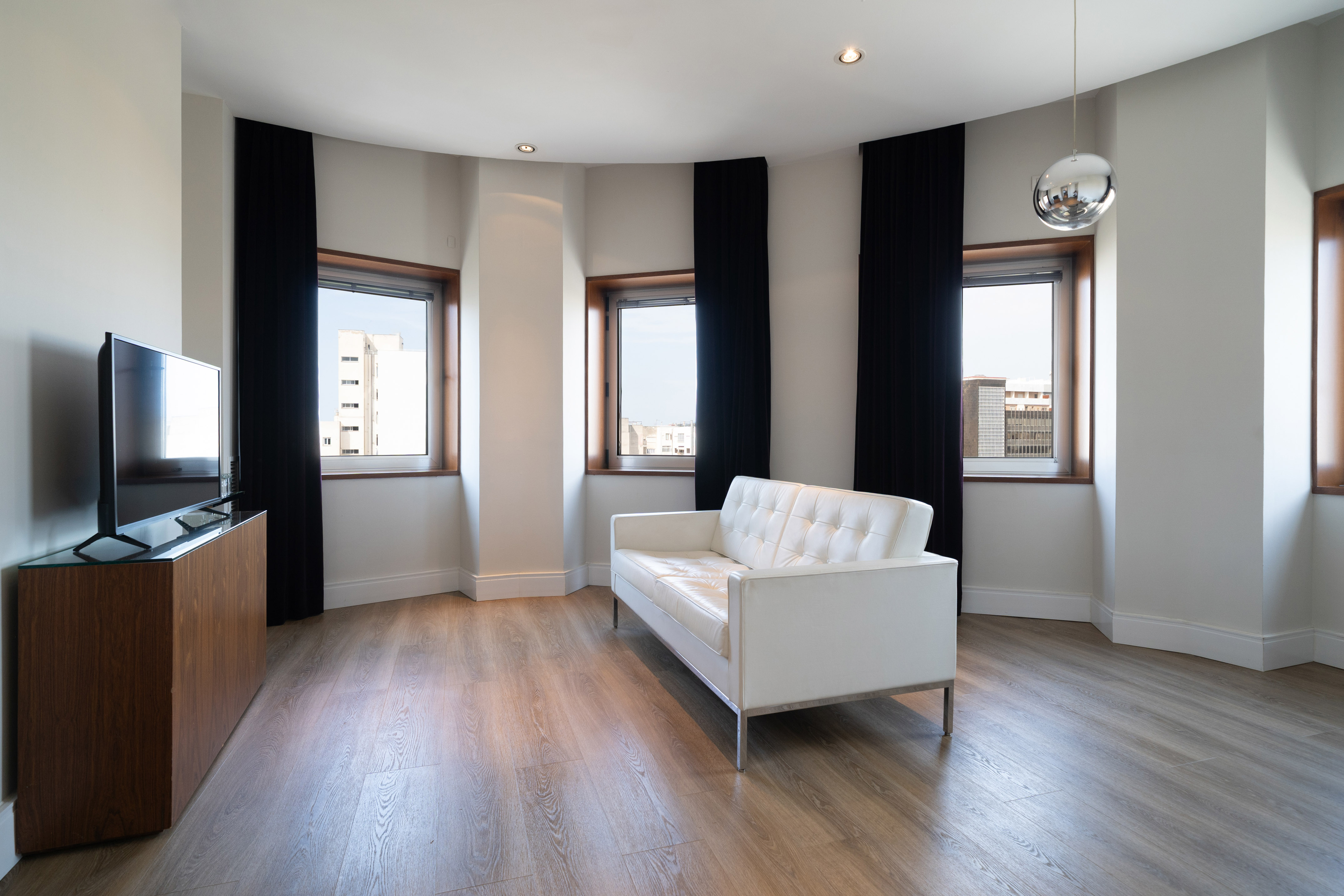 a room with a couch and windows