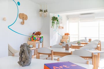 a room with white tables and chairs