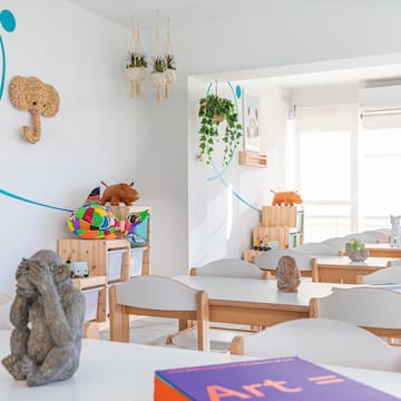 a room with white tables and chairs