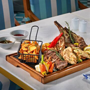 a tray of meat and vegetables on a table