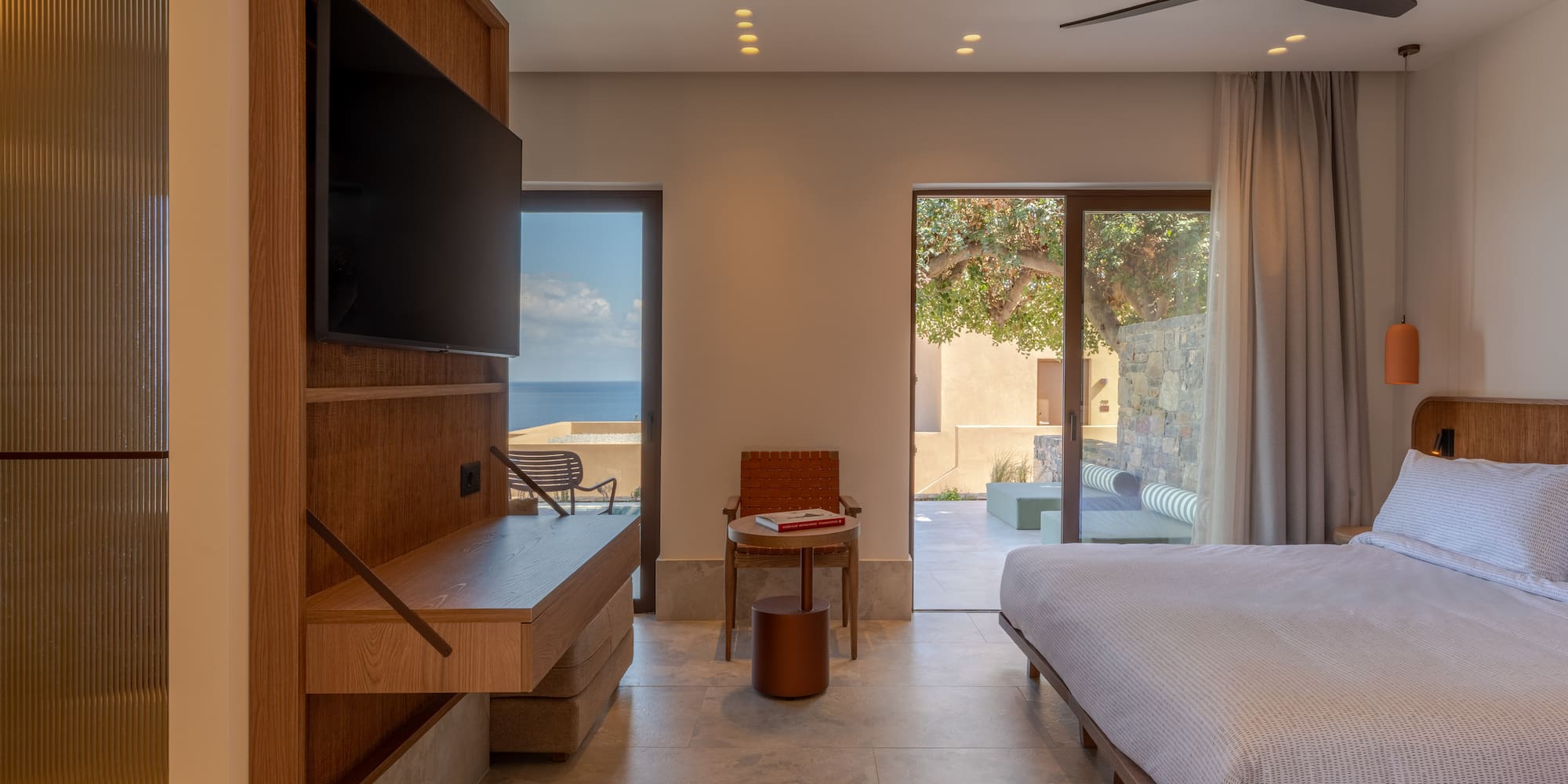 a room with a bed and a television