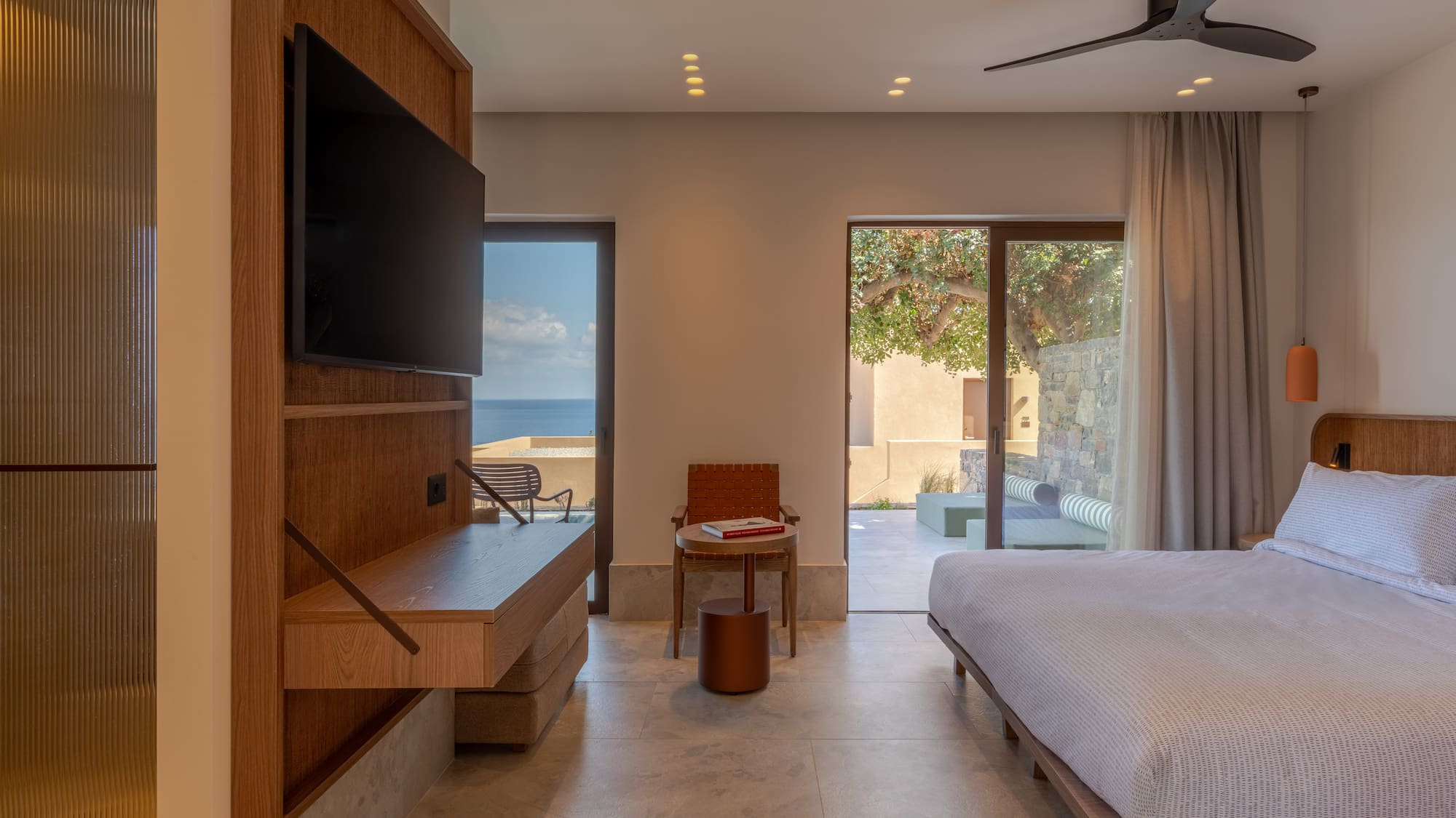 a room with a bed and a television