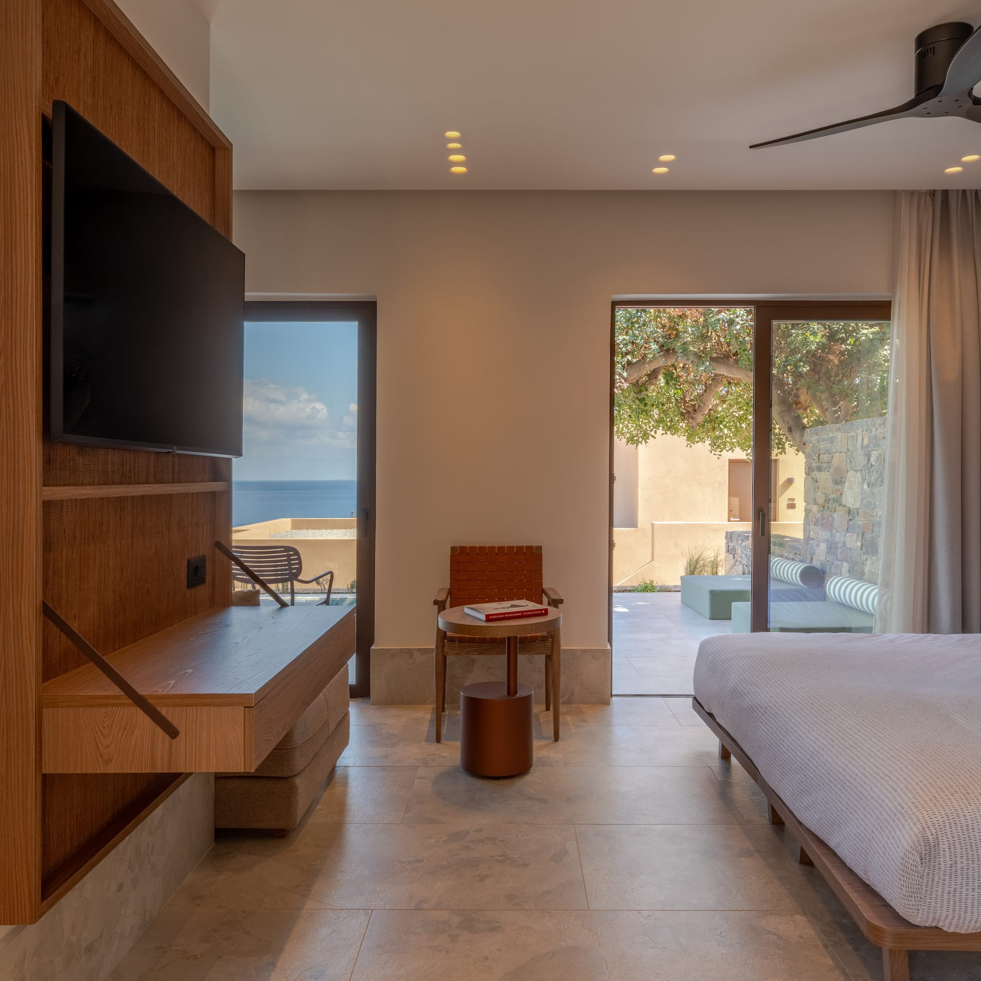 a room with a bed and a television