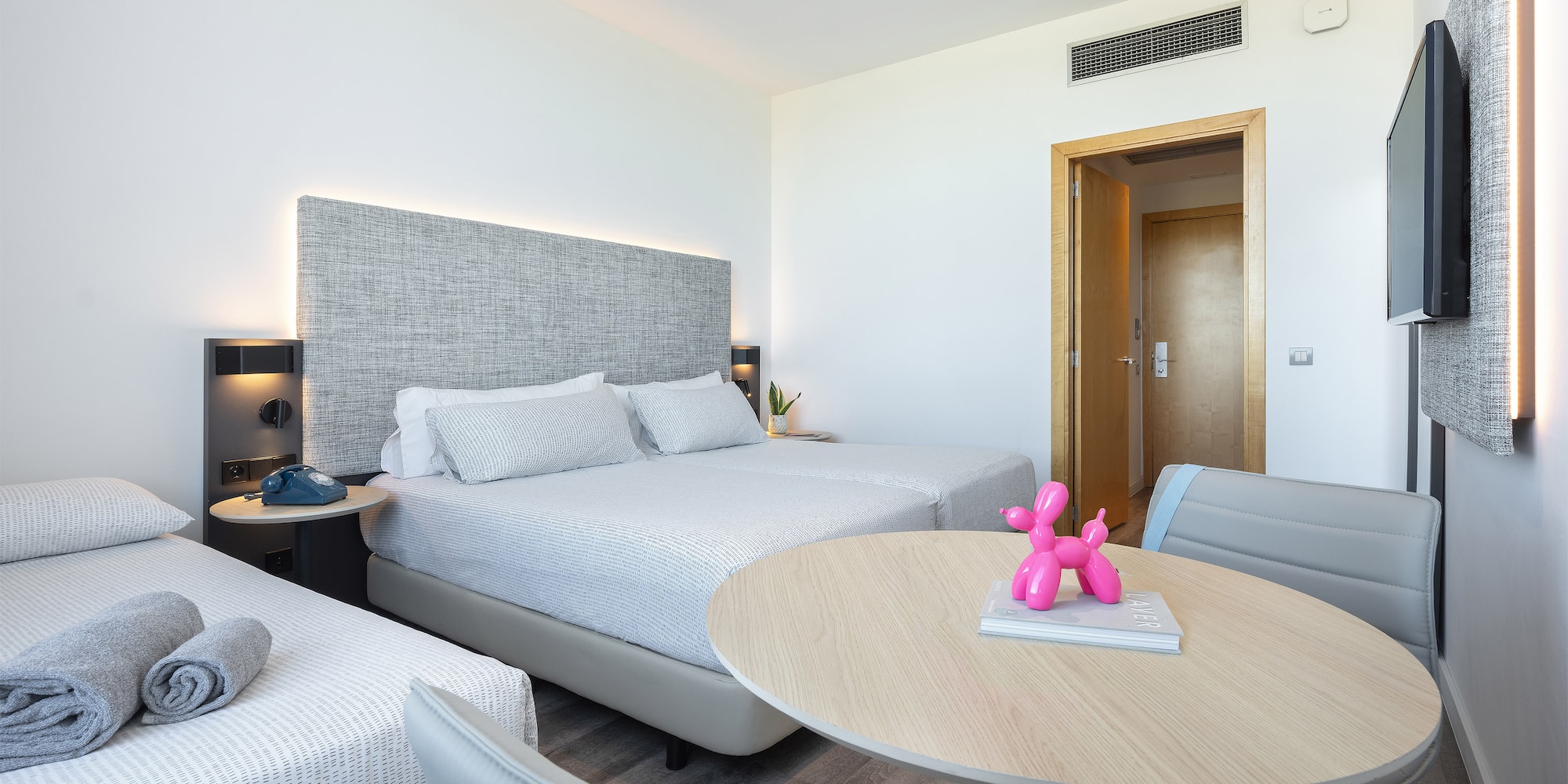 a room with two beds and a table