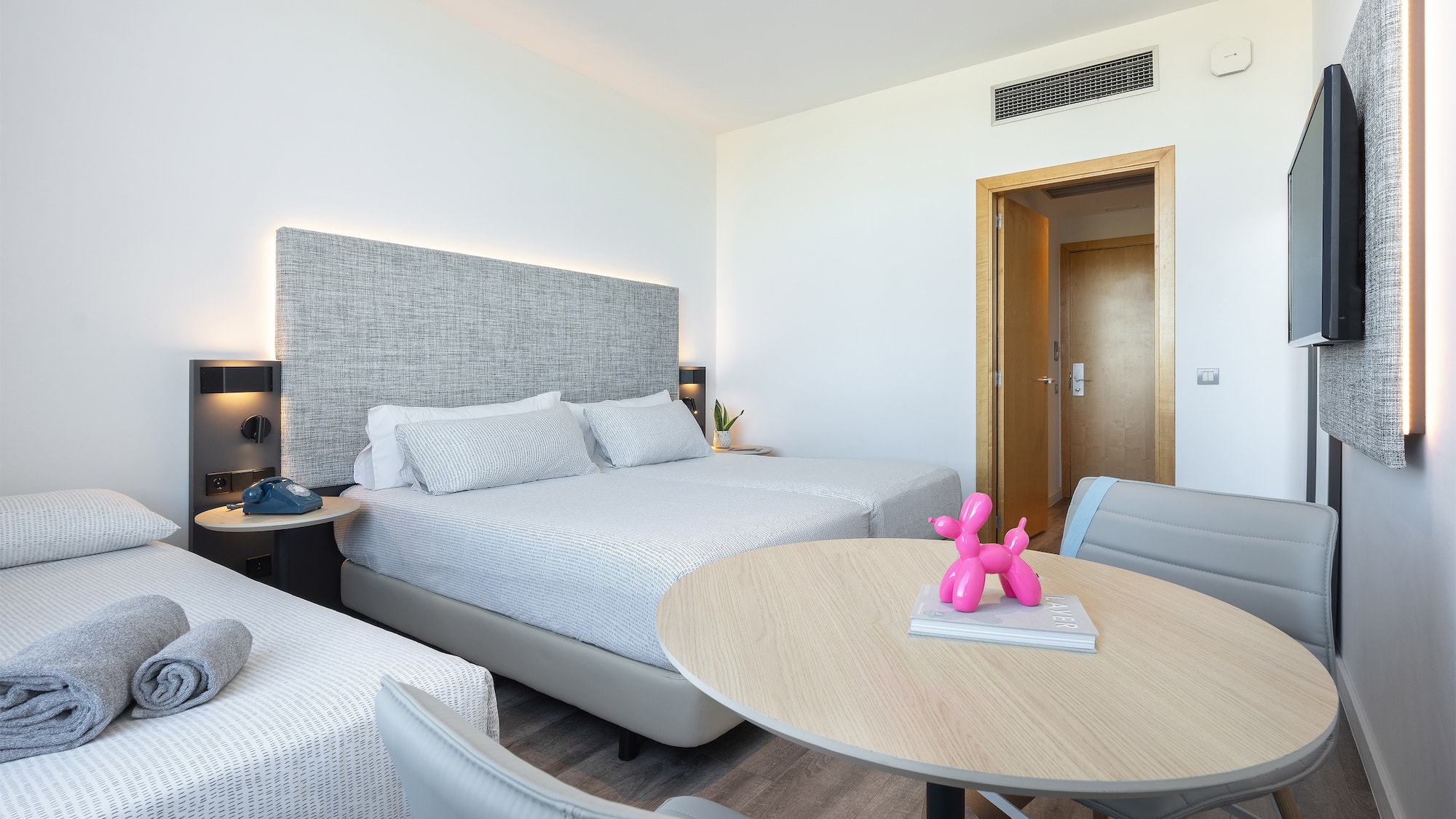 a room with two beds and a table