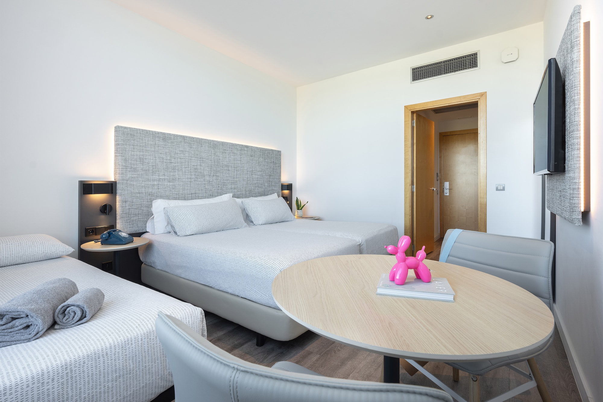 a room with two beds and a table