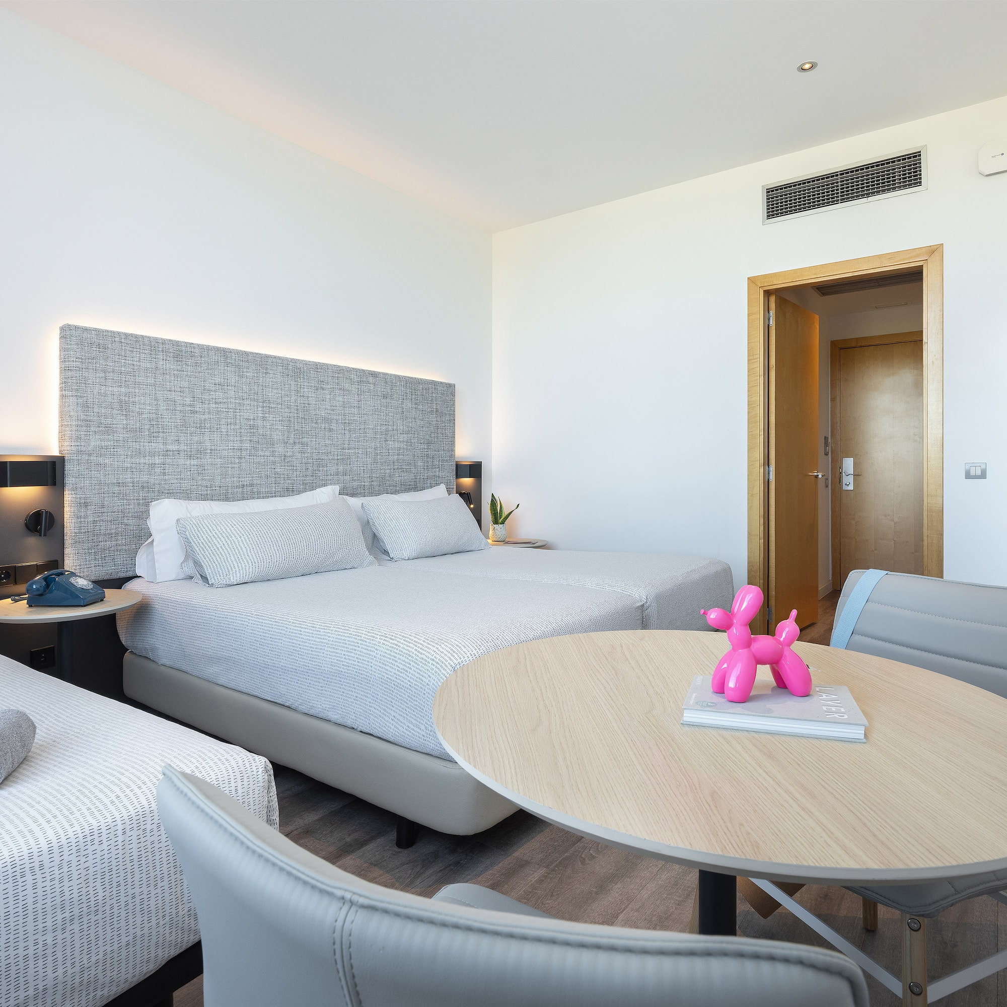 a room with two beds and a table