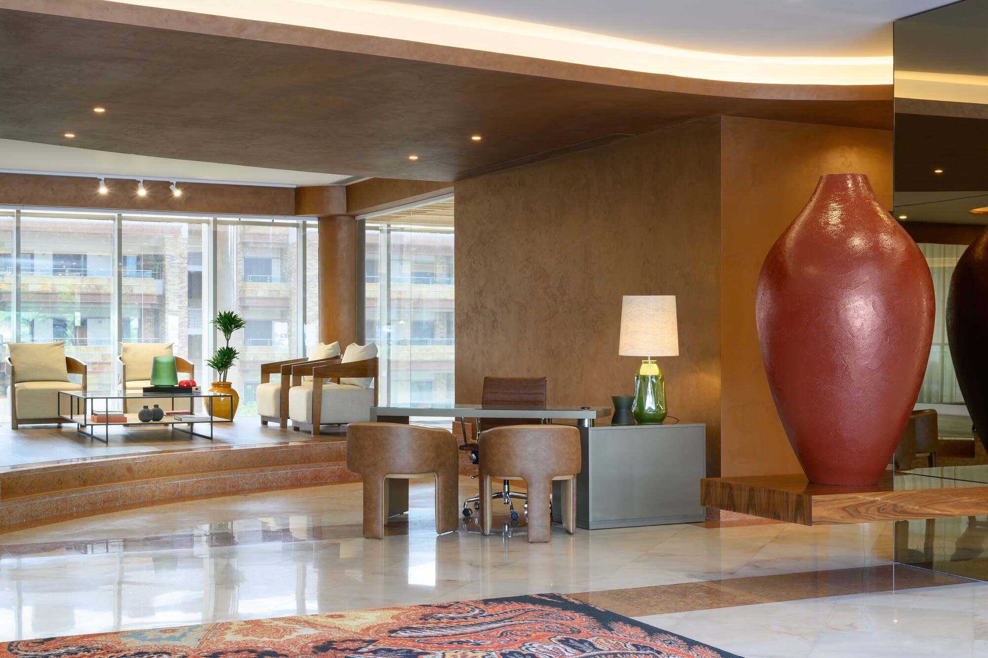 Luxurious hotel lobby reception with contemporary desk and seating area.