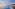 a beach with buildings and a body of water