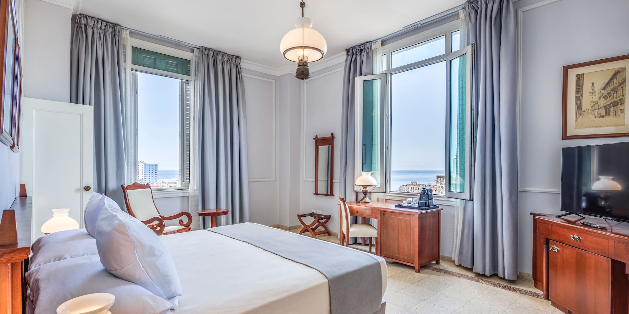 a bedroom with a bed and a television