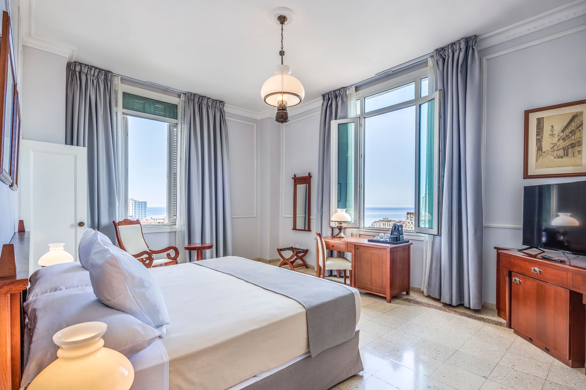 a bedroom with a bed and a television