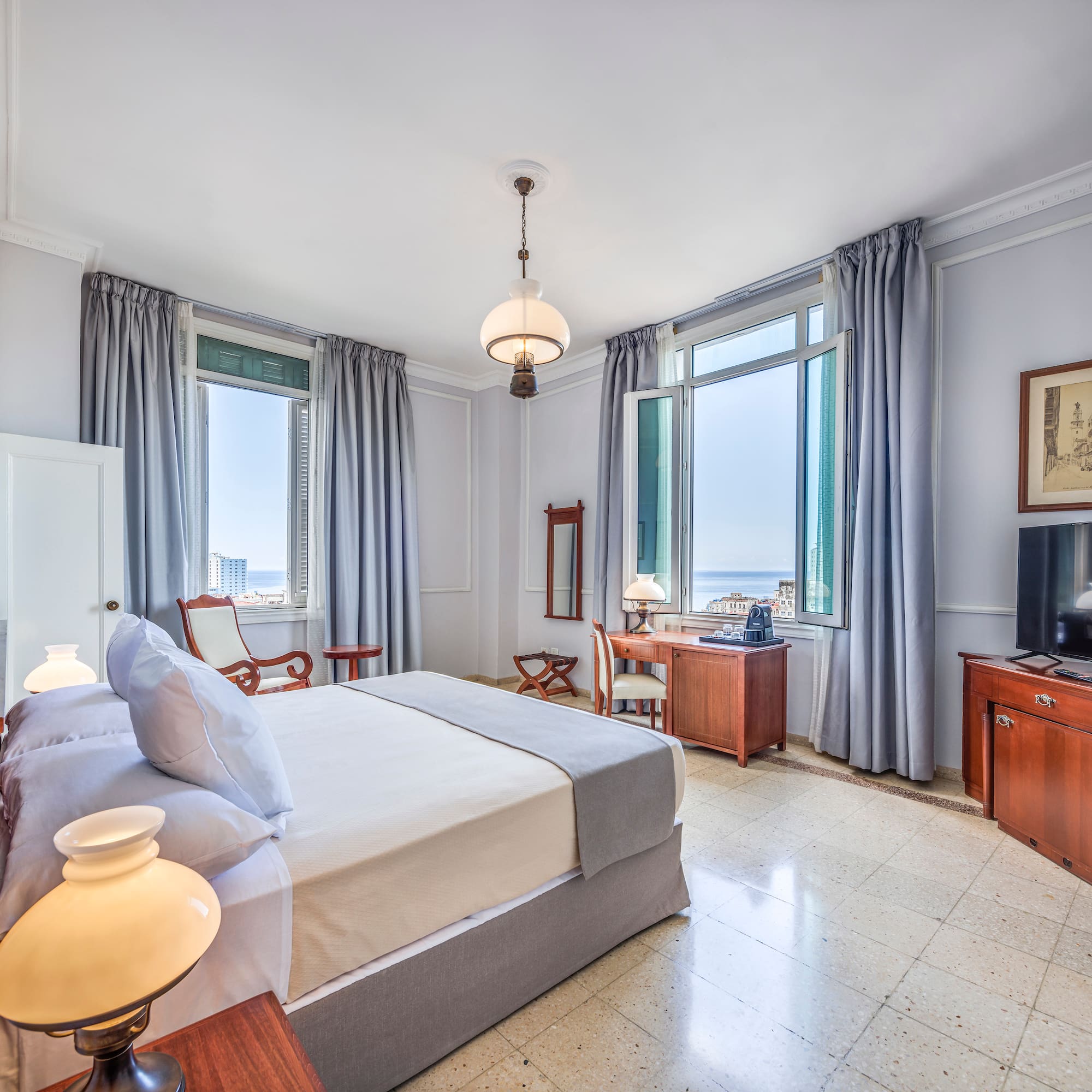 a bedroom with a bed and a television