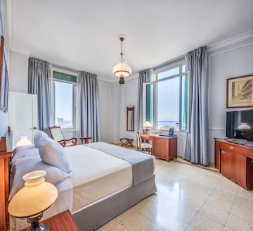 a bedroom with a bed and a television