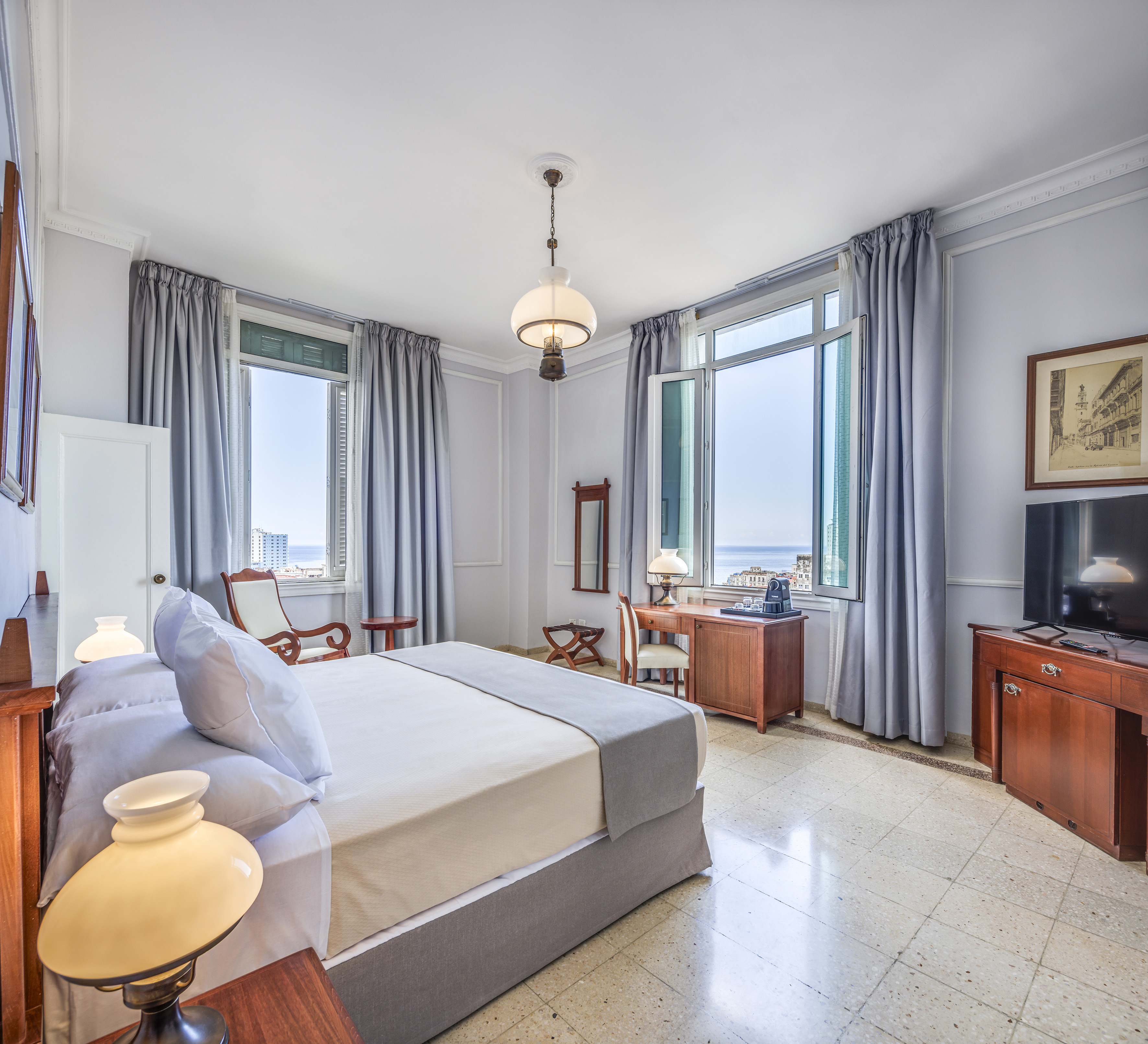 a bedroom with a bed and a television