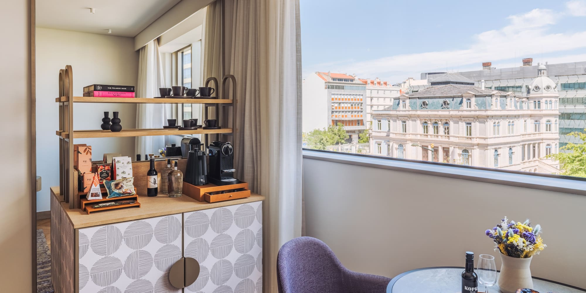 a room with a table and chairs and a window