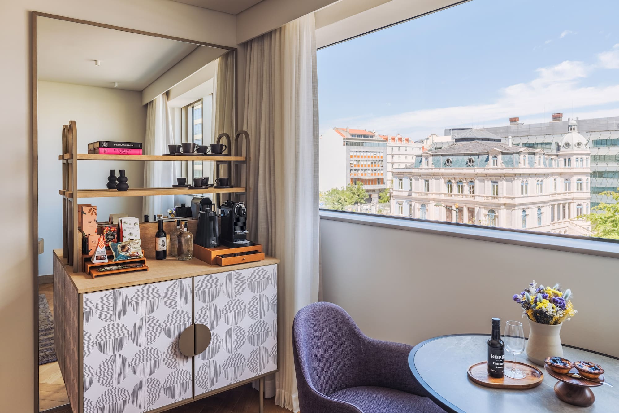 a room with a table and chairs and a window