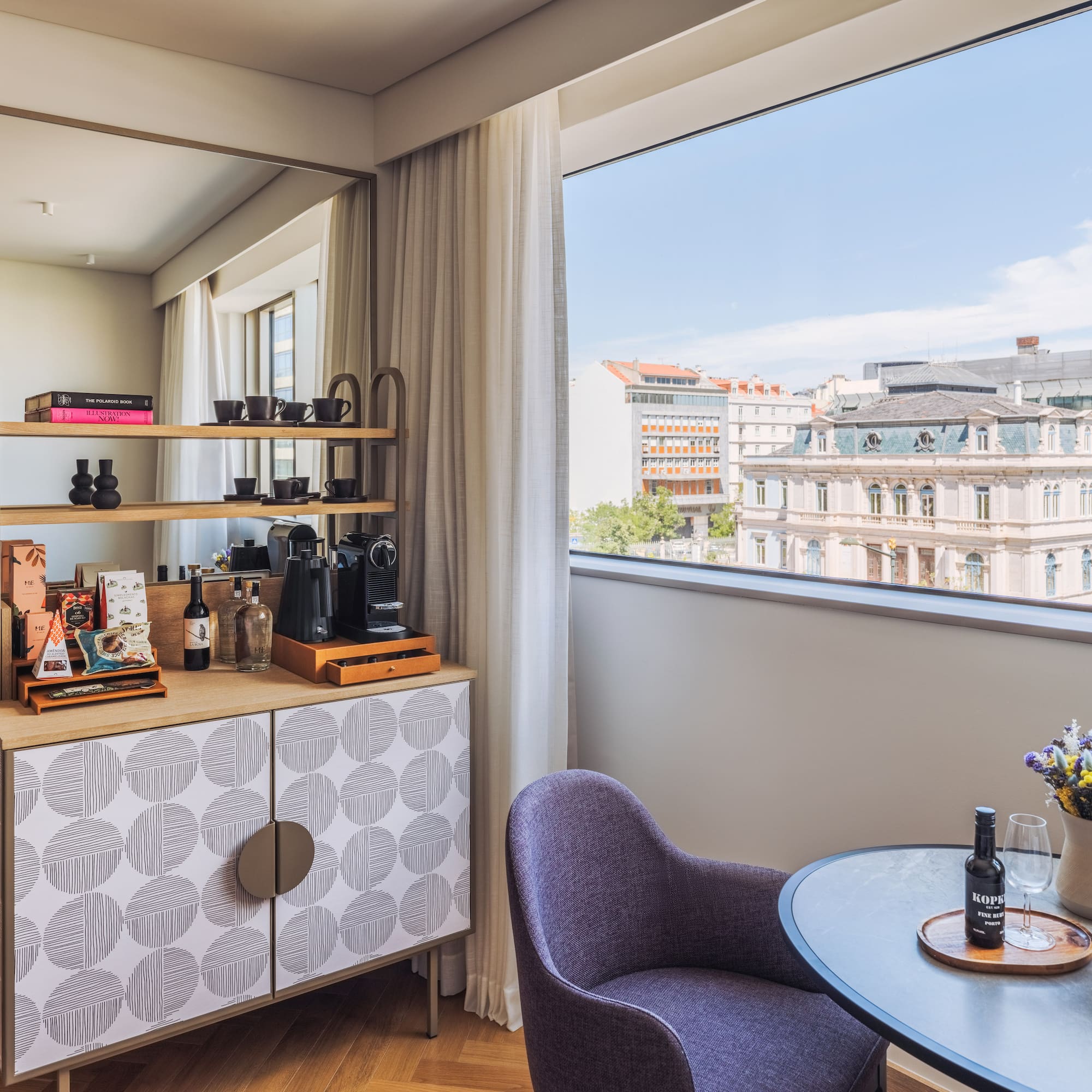 a room with a table and chairs and a window