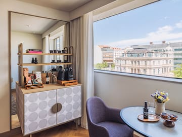 a room with a table and chairs and a window
