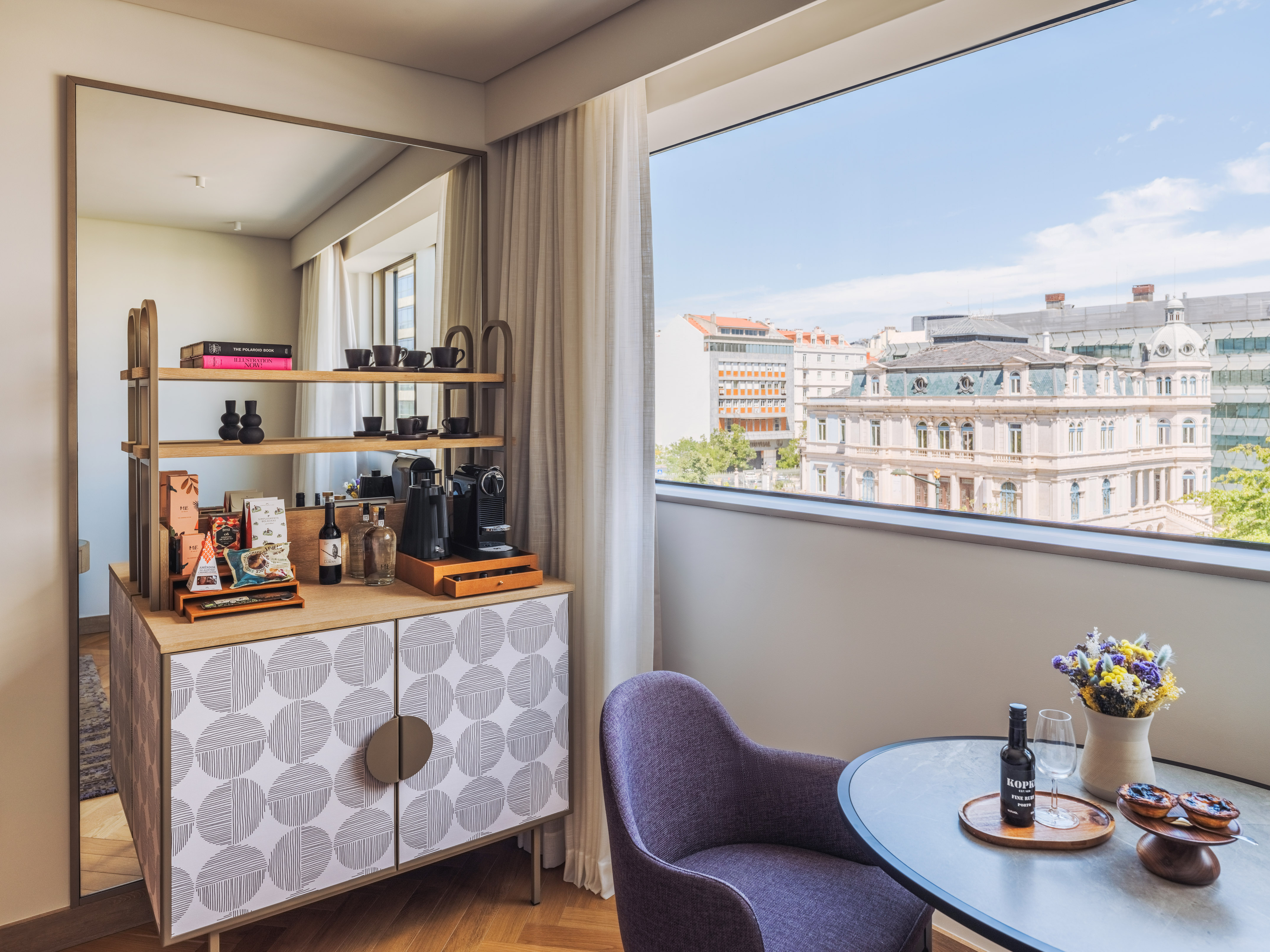 a room with a table and chairs and a window