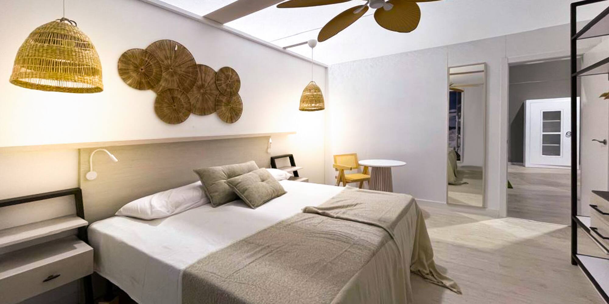a bedroom with a ceiling fan and a bed
