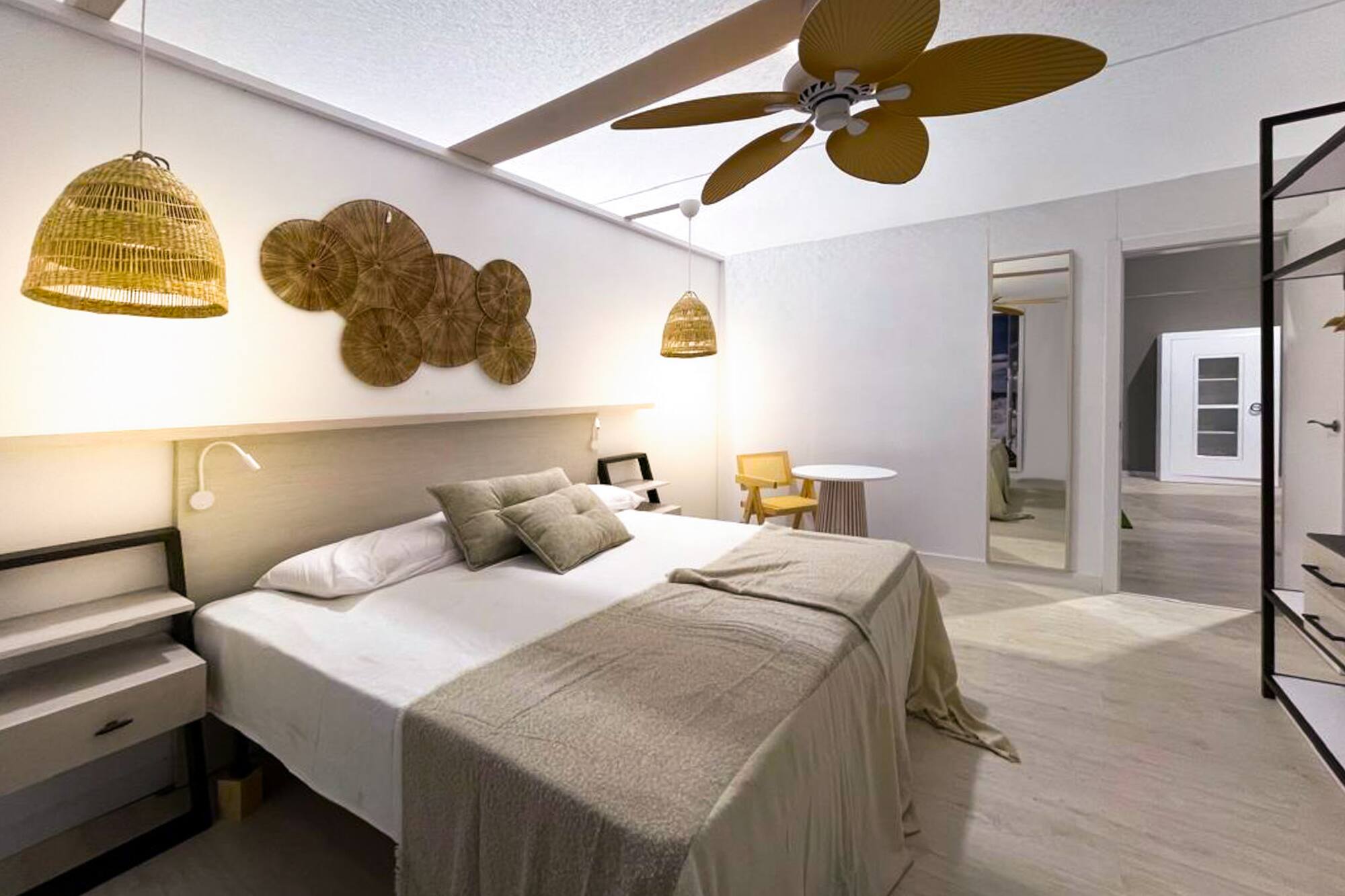 a bedroom with a ceiling fan and a bed