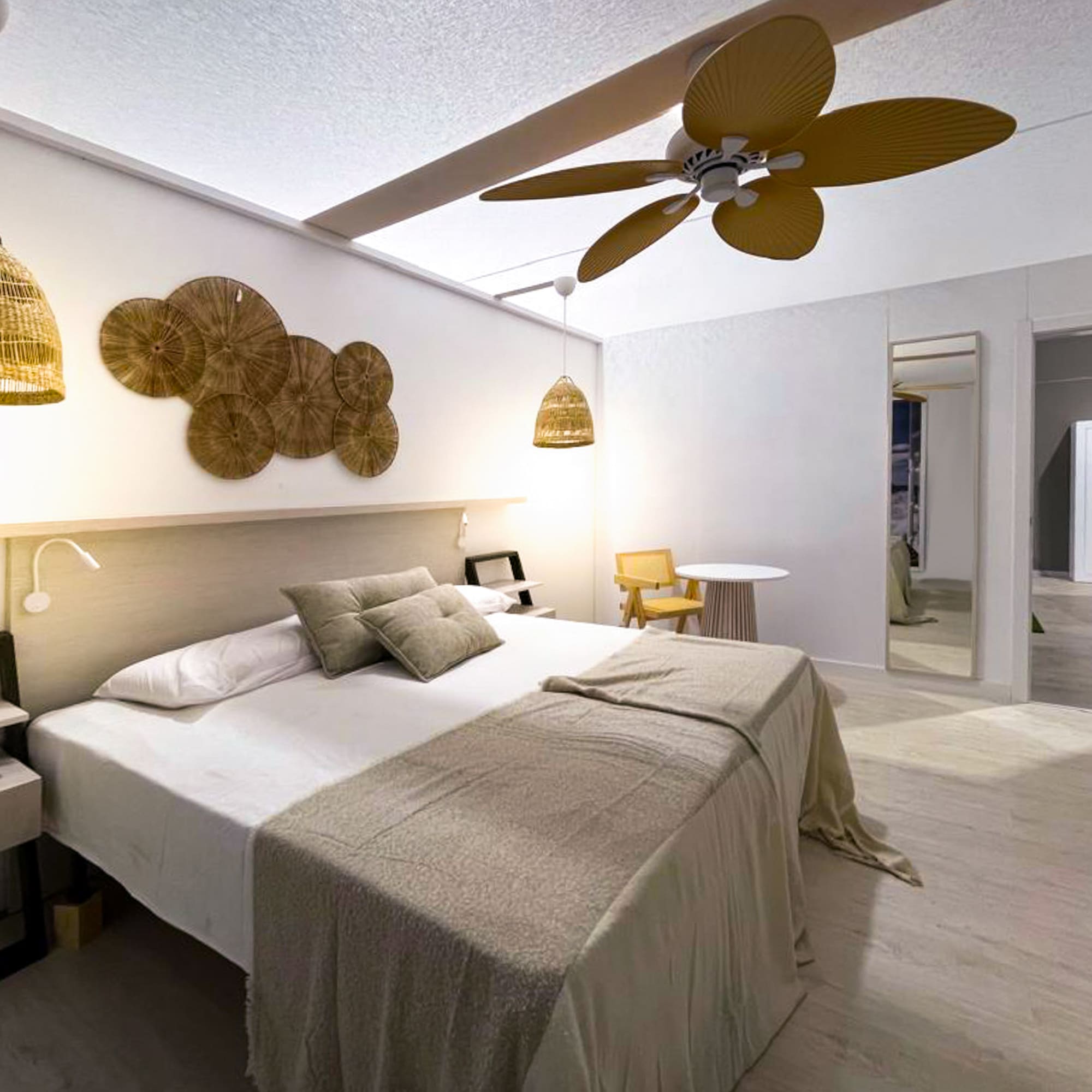 a bedroom with a ceiling fan and a bed
