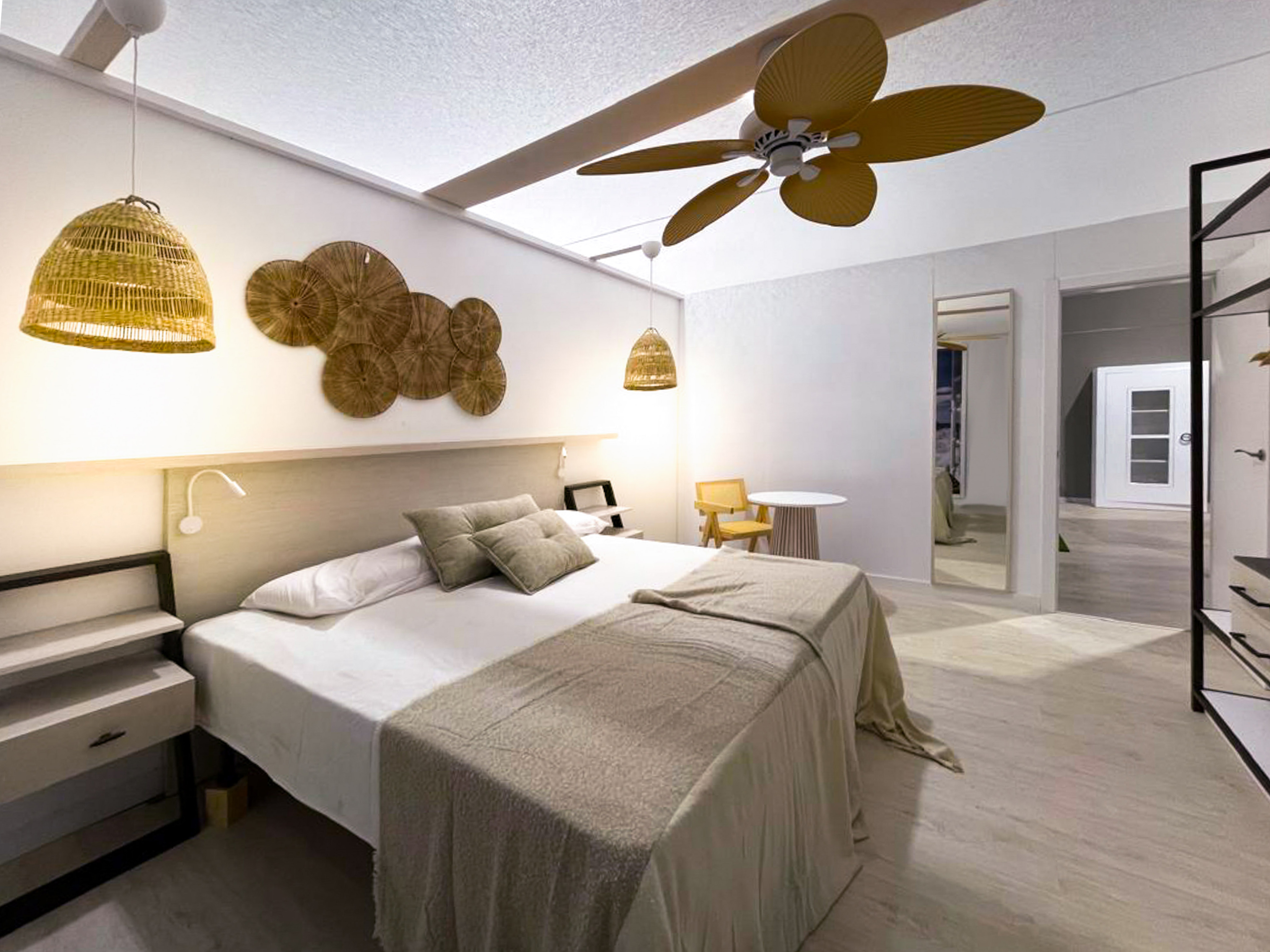 a bedroom with a ceiling fan and a bed