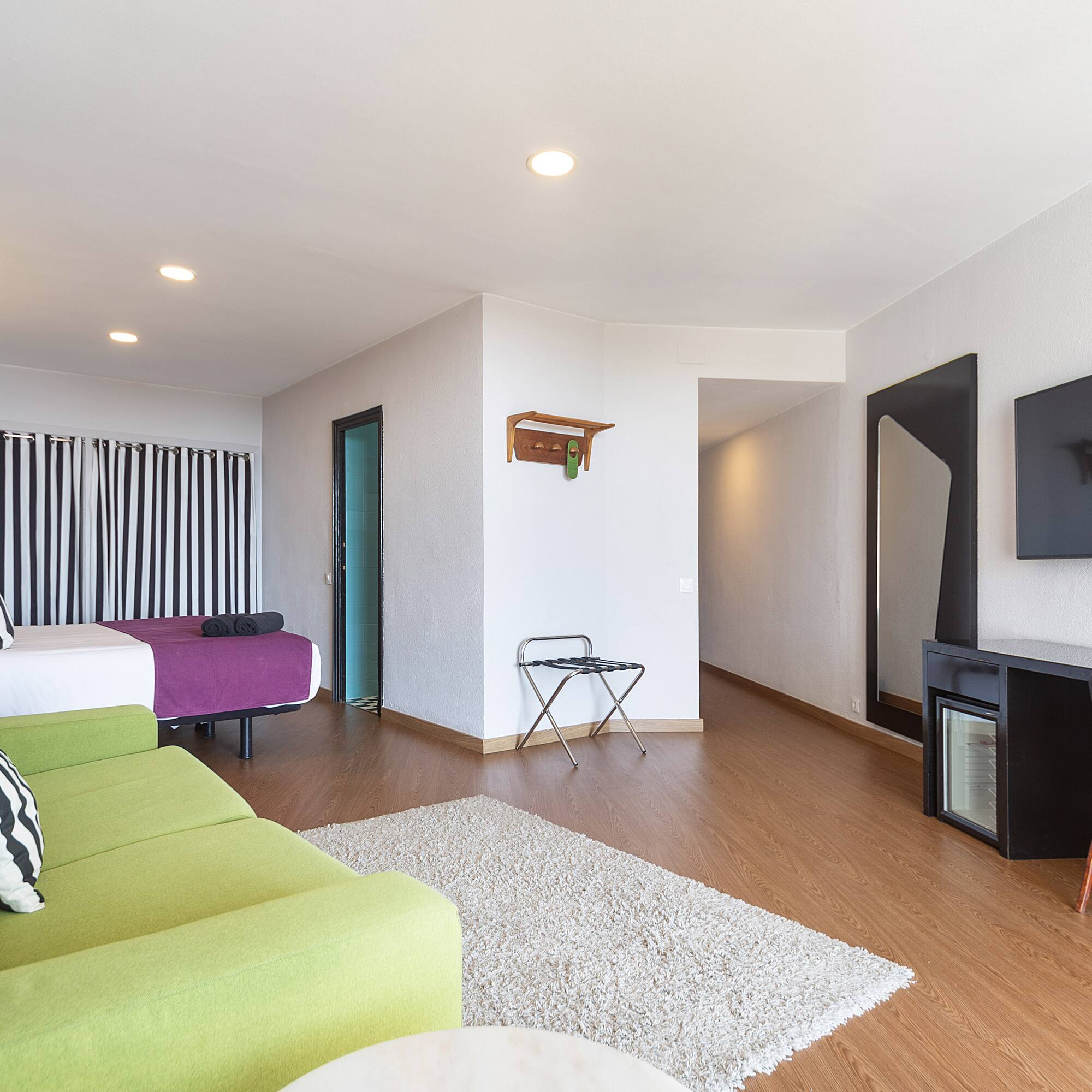 a room with a television and a bed