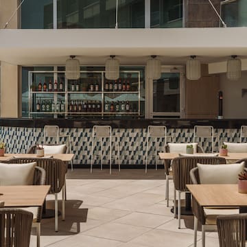 a patio with tables and chairs