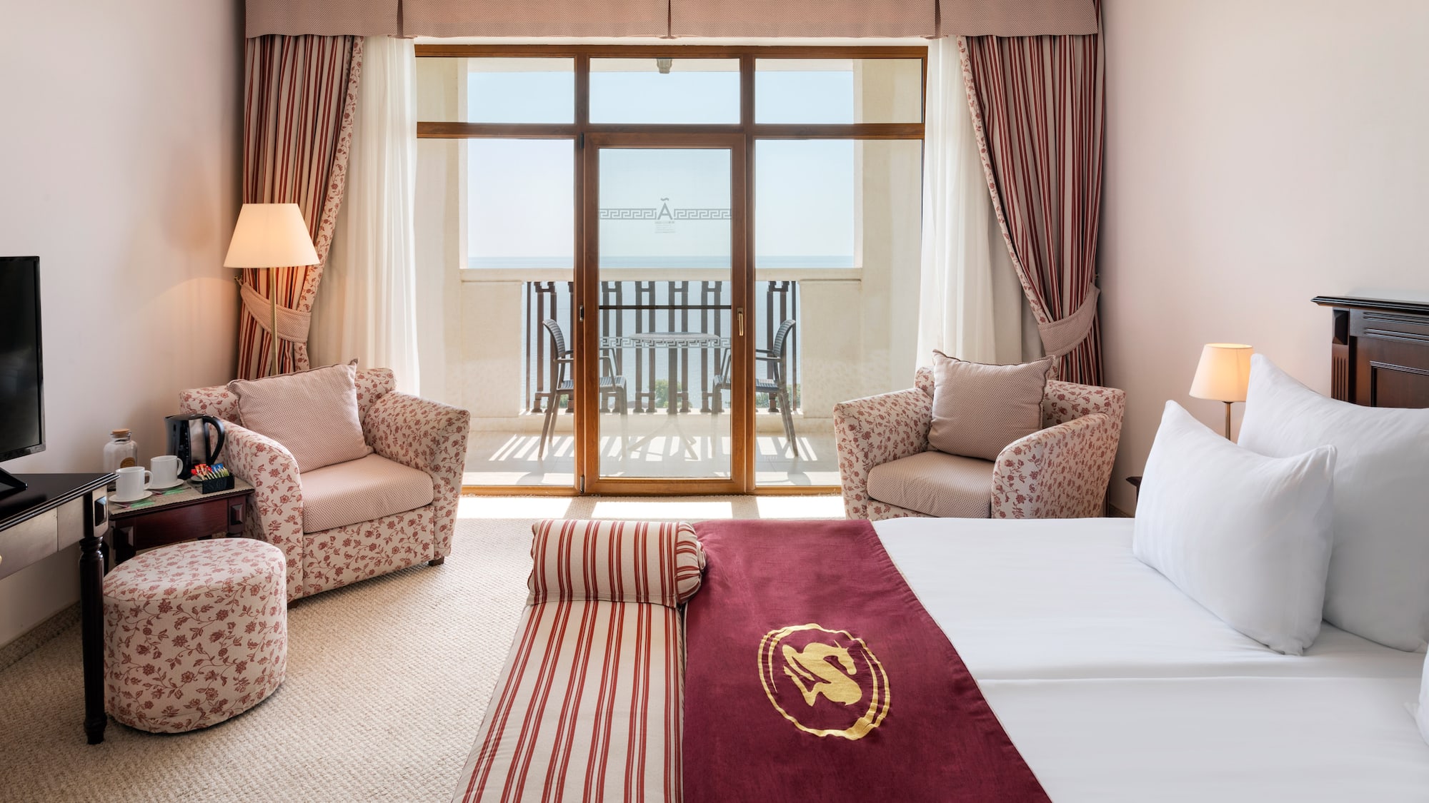 a room with a bed and chairs