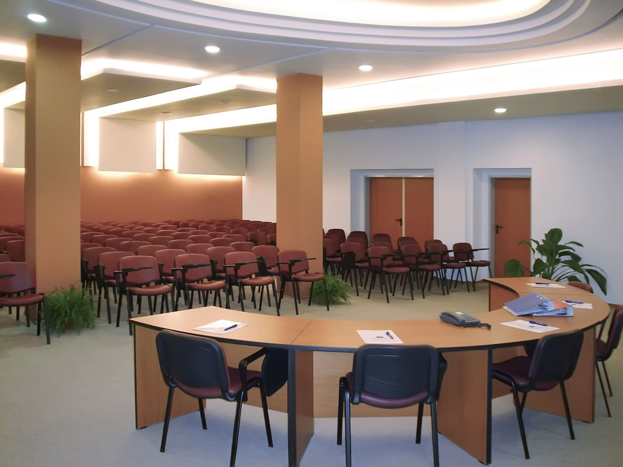 a room with a round table and chairs 