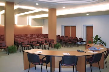 a room with a round table and chairs 
