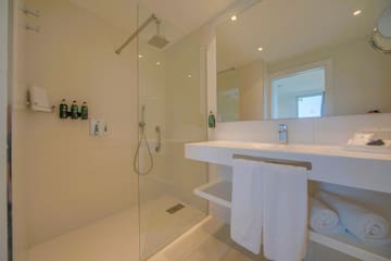 a bathroom with a shower and a sink