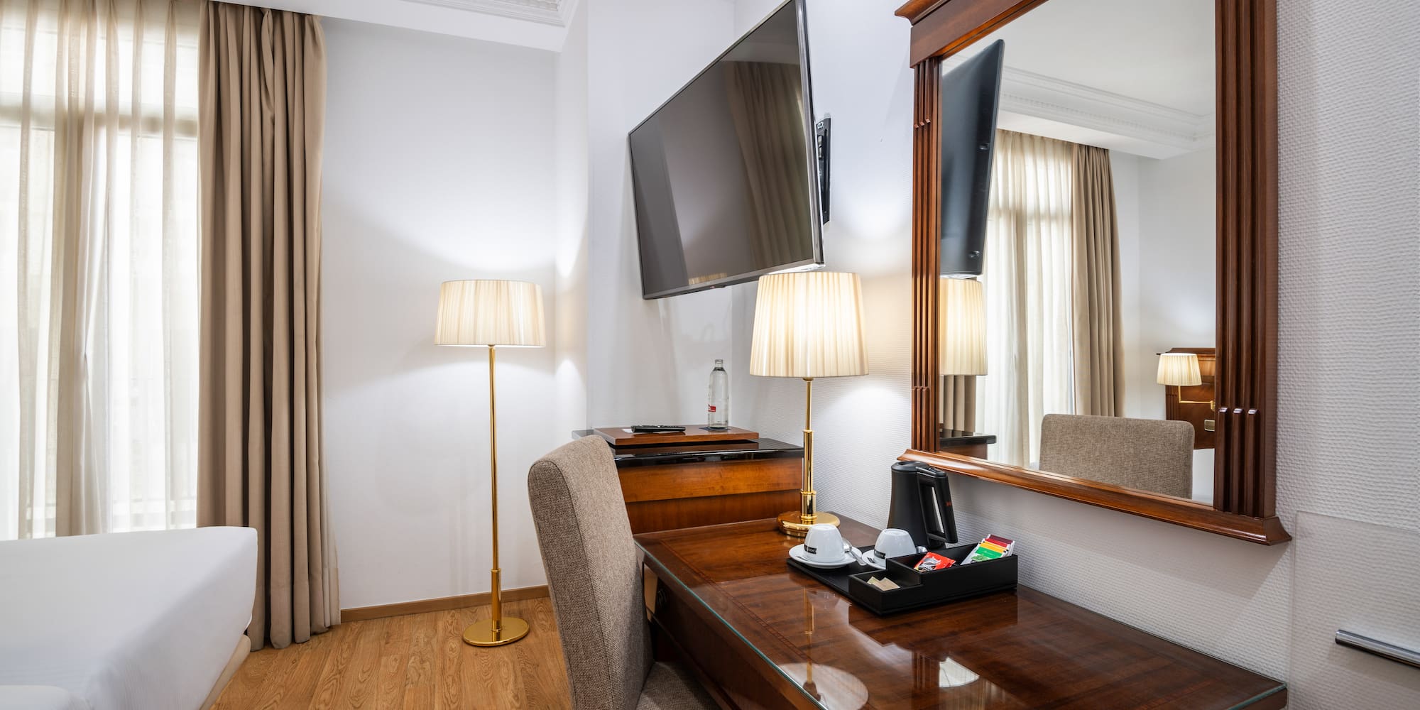 a room with a mirror and a desk