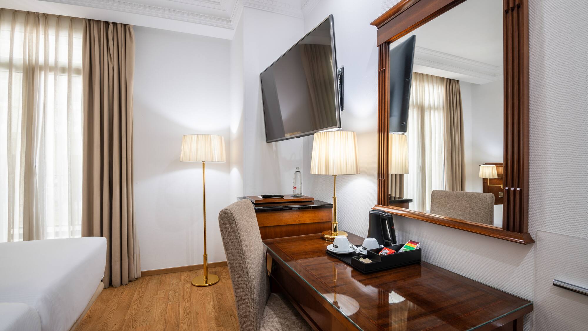 a room with a mirror and a desk