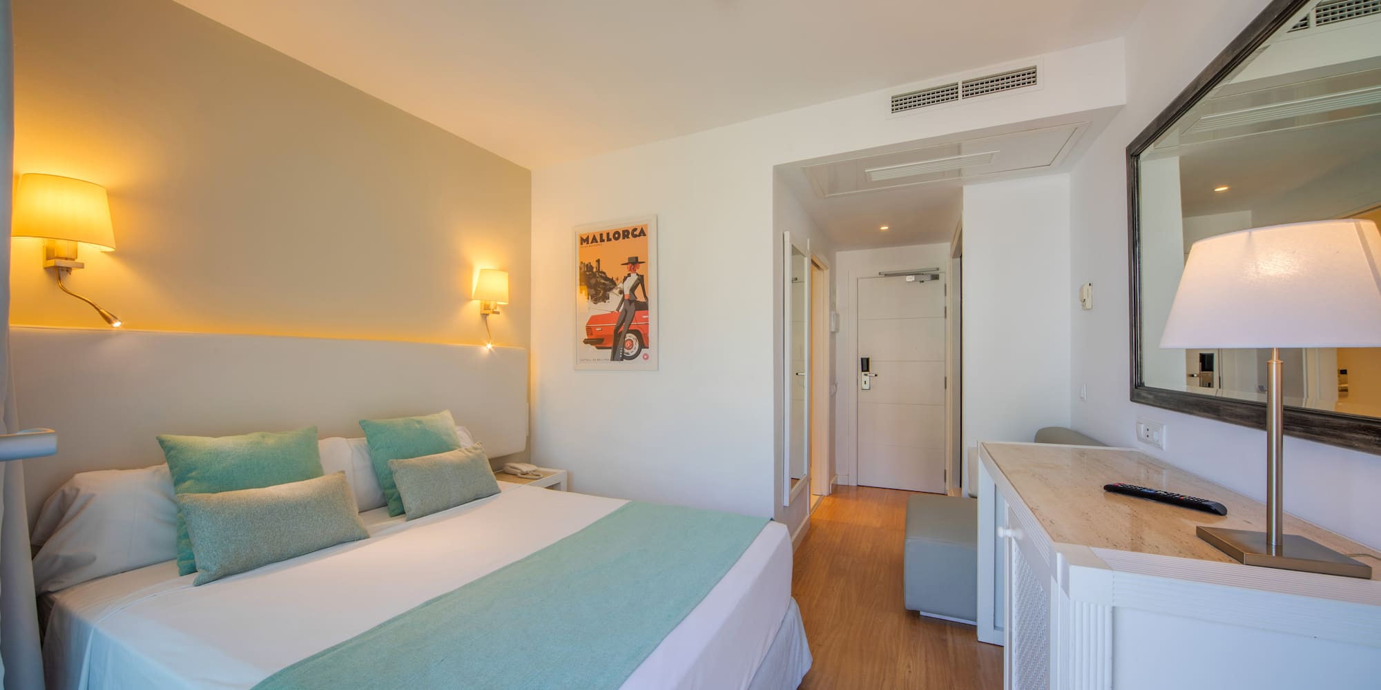 a bedroom with a bed and a mirror