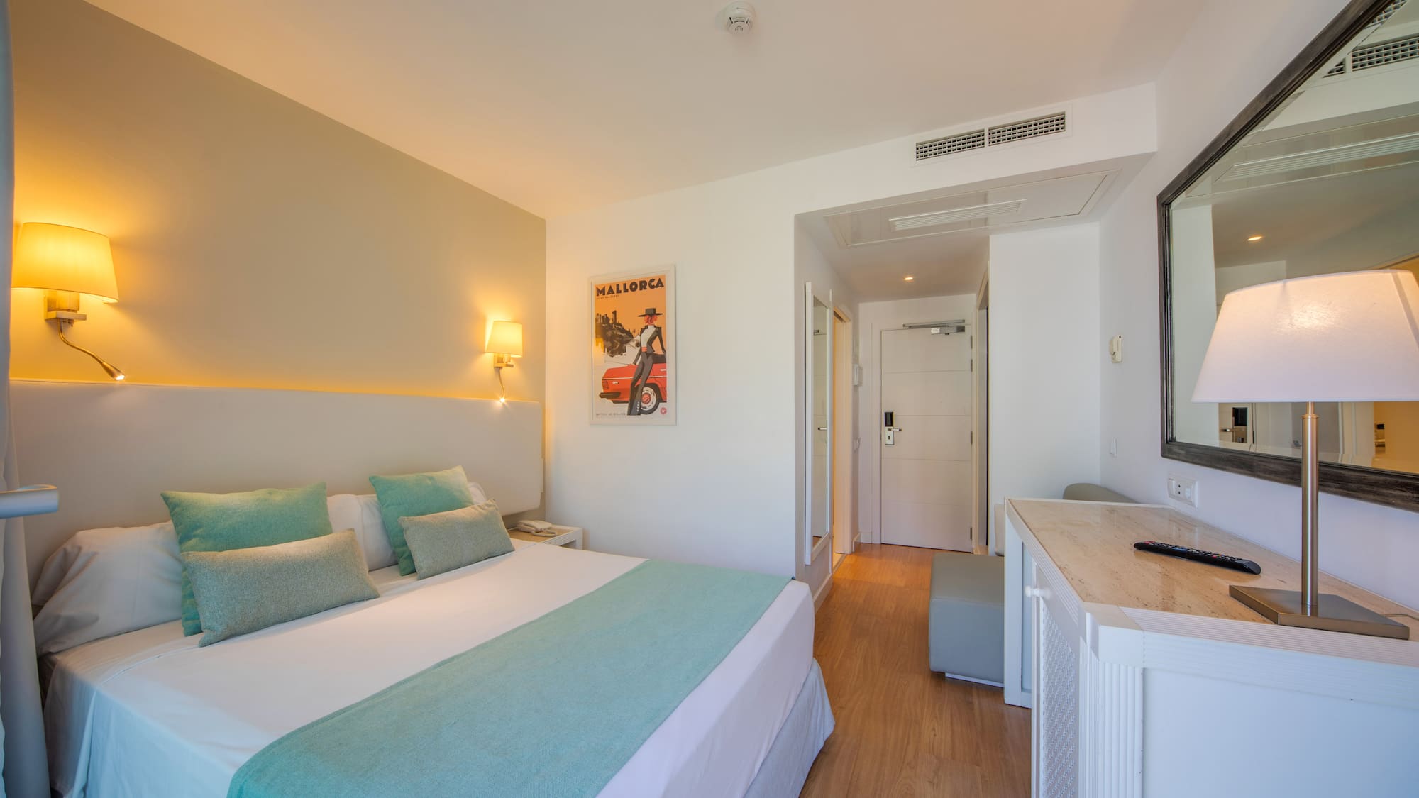 a bedroom with a bed and a mirror