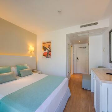 a bedroom with a bed and a mirror