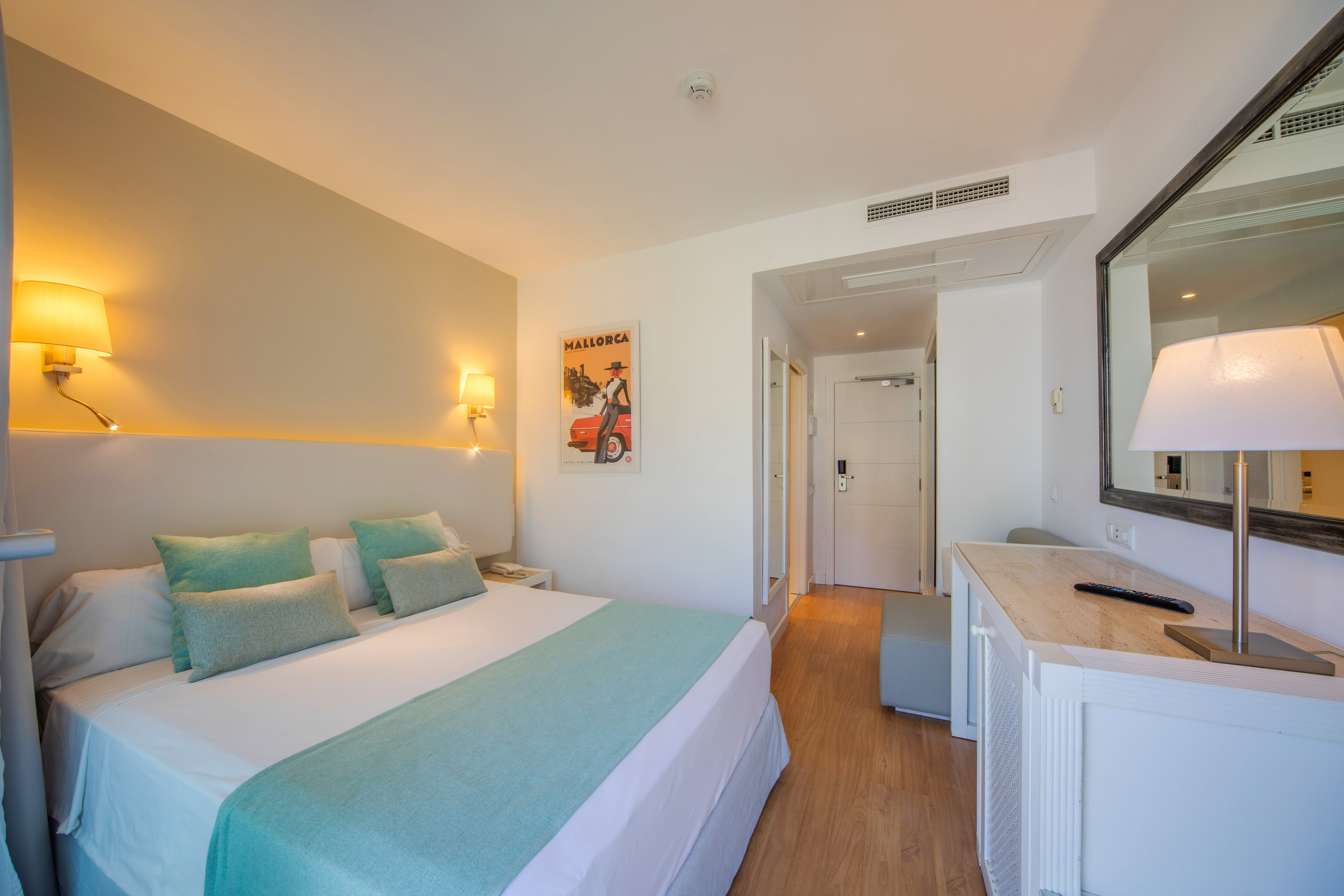 a bedroom with a bed and a mirror