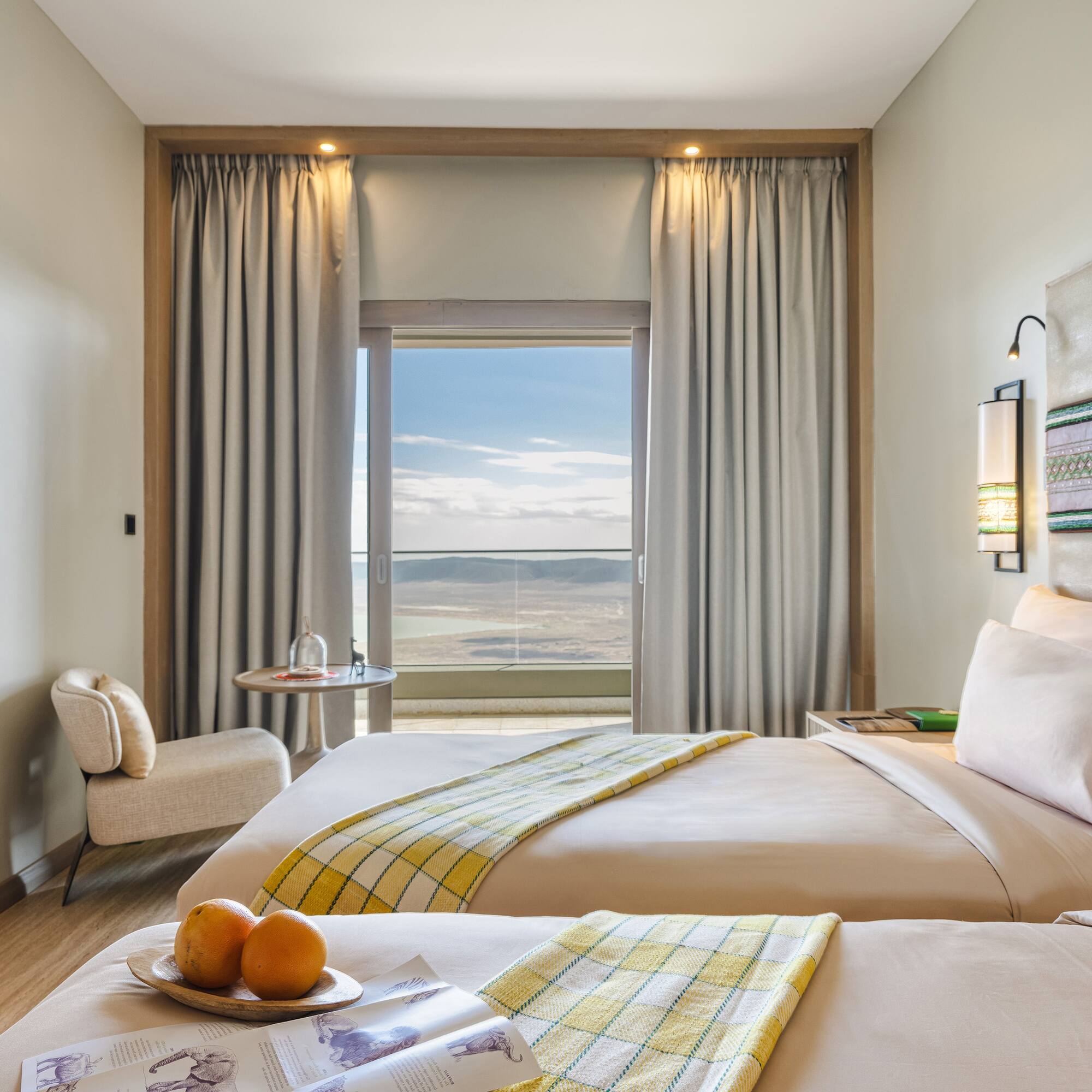 a room with two beds and a table with oranges