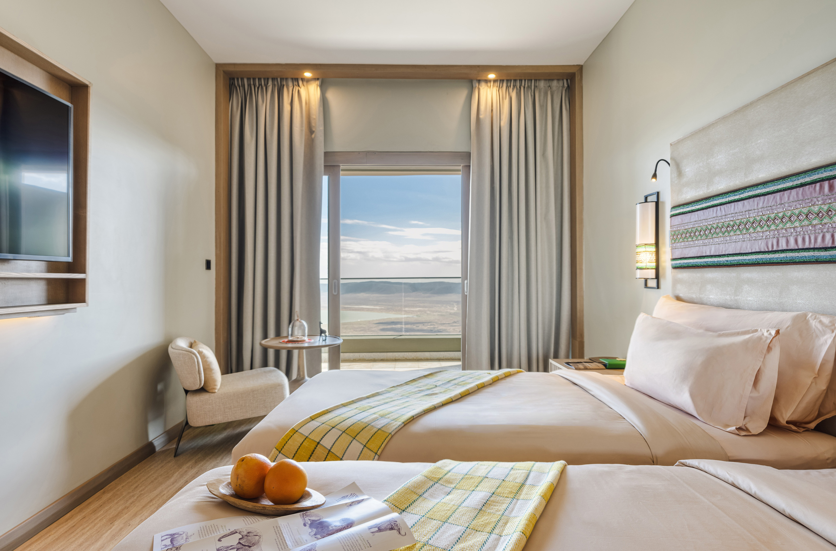 a room with two beds and a table with oranges