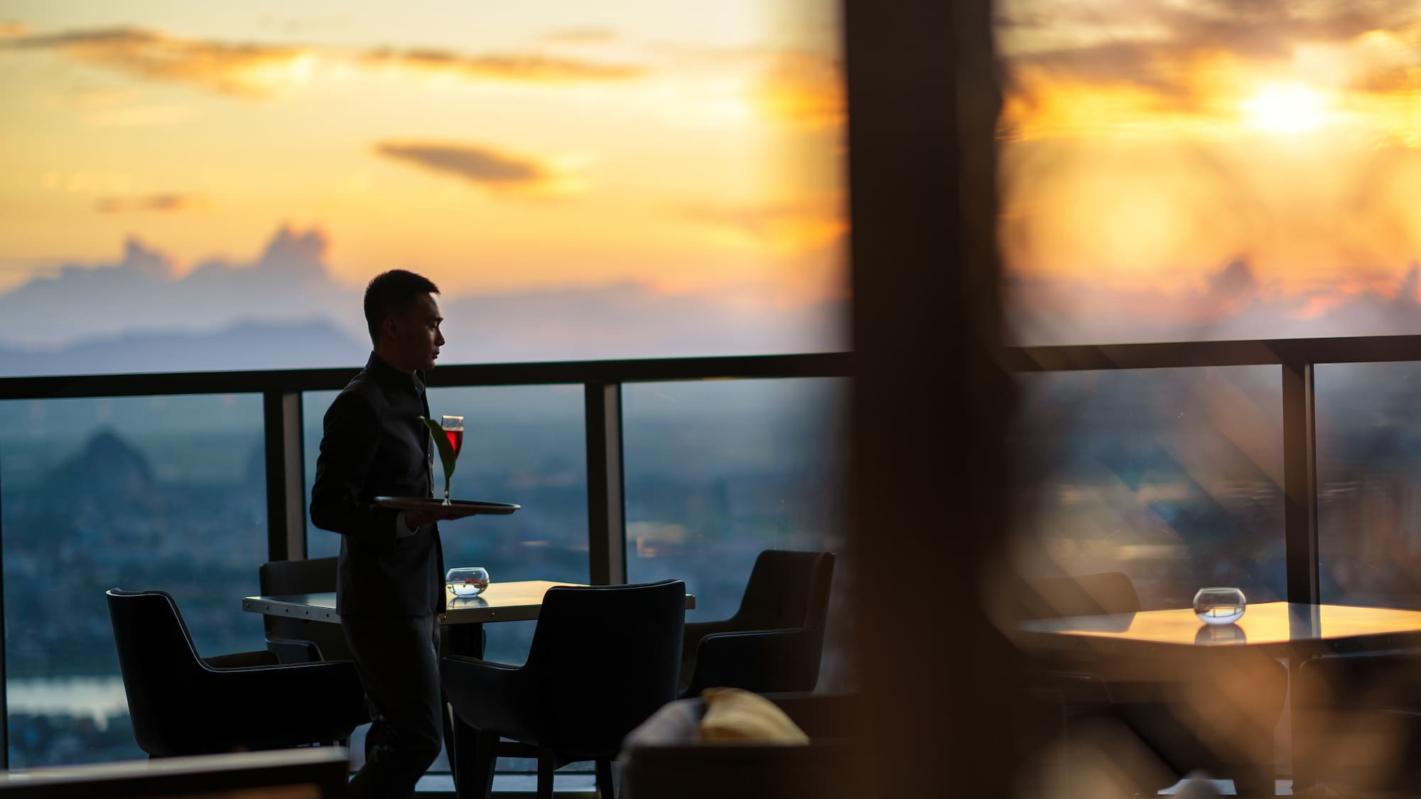 a man holding a tray with a drink in it