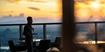 a man holding a tray with a drink in it