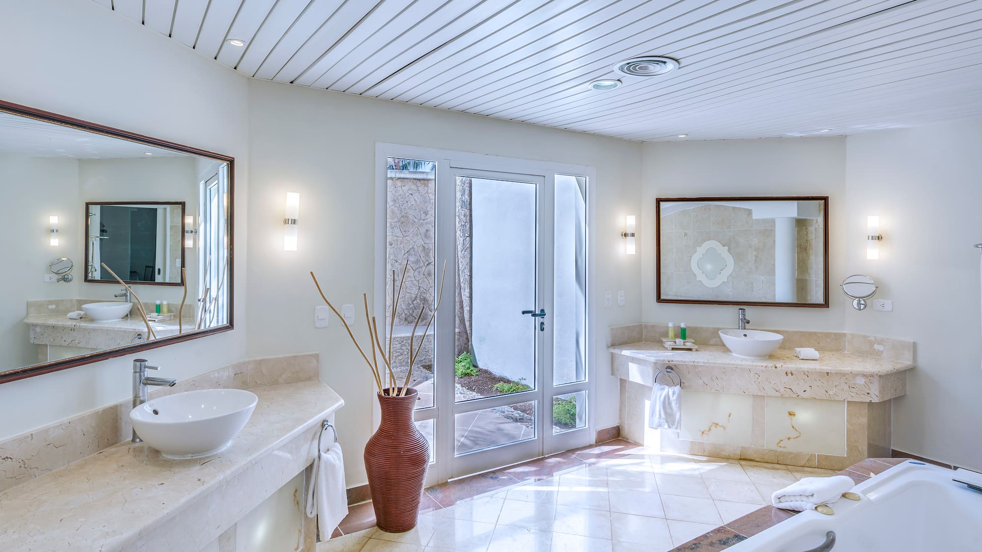 a bathroom with a tub and sinks